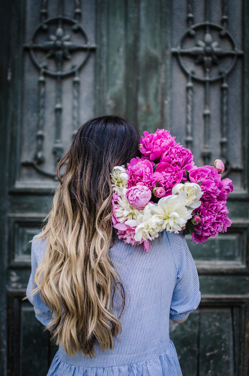 huge peonies bouquet on the shoulder